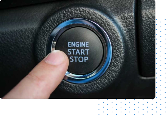 person with a finger on a push-to-start car button